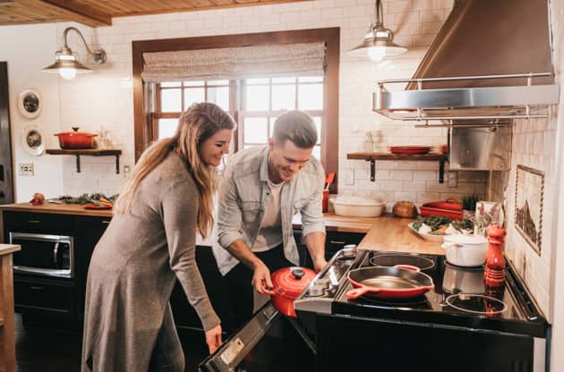 A couple organizing a kitchen together.